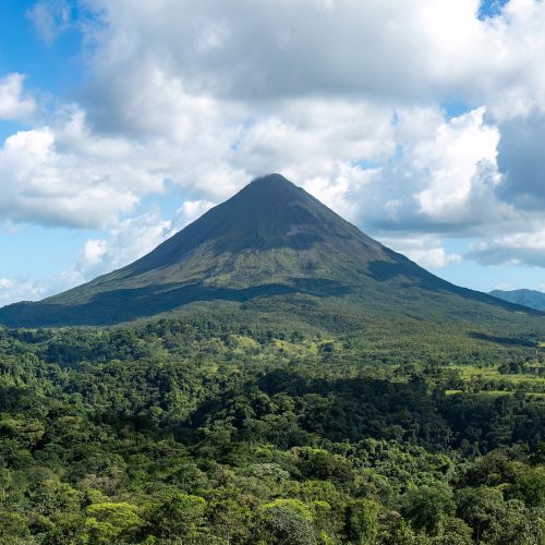 The cone of Arenal Volcano above rainforest and hot springs