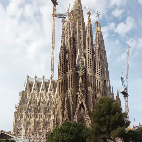 The Sagrada Familia basilica towers against a blue Barcelona sky